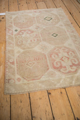 Angled view of a vintage Dosemealti rug showing the octagonal gul pattern and even wear.