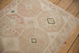 Corner view of a vintage Dosemealti rug showing its distressed, low-pile hand-knotted weave.