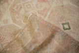 The hand-knotted foundation and low, worn pile of a vintage Turkish Dosemealti rug.
