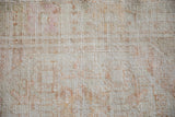 Worn texture of a vintage Turkish Oushak showing exposed knot heads and ivory foundation.
