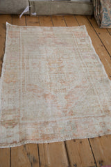 Distressed vintage Oushak rug showing considerable wear to the pile and soft, faded colors.