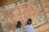 Distressed texture, pale ruby red Anatolian rug with tree of life and vine border.