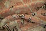 Textured pile of the distressed vintage Anatolian rug, revealing soft ruby red, ivory, and brown motifs.