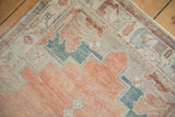 Worn hand-knotted pile on the Oushak rug's stepped corner spandrel in cantaloupe and silver.
