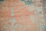 Woven numbers reading '1969' in the cantaloupe melon pile of a distressed Turkish Oushak rug.