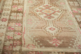 Vintage distressed Oushak rug pile detail, highlighting abrashes dusty mauve and coffee brown tones.