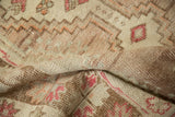 Texture of vintage distressed Oushak rug pile, featuring abrash and worn knot heads.