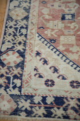 Detail of distressed vintage Anatolian rug featuring cobalt blue finned buds and dusty blush patterns.