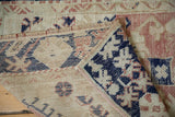 Hand-knotted Anatolian rug's distressed pile, reverse foundation, dusty blush, and cobalt blue.