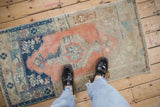 Cantaloupe and cobalt blue abrash texture on a vintage distressed Oushak runner underfoot.
