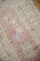 Close-up view of mostly even wear to the knot heads on this vintage distressed Turkish rug.