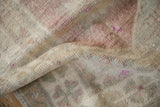 Texture detail of a vintage distressed rug with mostly even wear across the knot heads.