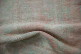 Distressed vintage Oushak rug pile showing pale blush and mint green with wear to knot heads.