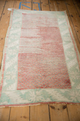 Vintage Anatolian runner with heavy abrashes across its raspberry and pale mint green pile.