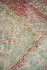 Detail of the hand-knotted foundation and secured side selvage of a vintage rug.