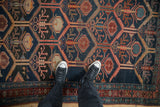 Antique Malayer rug's unidirectional plant design, hexagonal panels in navy, madder red, ivory.