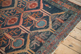 Antique Malayer rug with serrated leaf motif in geometric panels, navy, madder red, dusty teal.