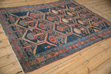 Antique Malayer rug detail, navy field with madder red hexagonal panels and serrated leaves.
