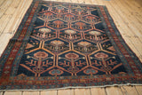 Antique Malayer rug corner detail, displaying fringe and madder root red border with serrated leaf motifs.