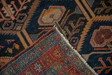 Antique Malayer rug detail: hand-knotted pile, navy and red patterns, visible wear, intact selvage.