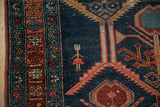Detail of unique person figure and serrated leaf border on an antique Malayer rug.
