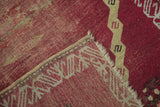 A folded corner of an antique Anatolian rug reveals its hand-knotted foundation and side selvage.