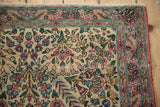 Hand-knotted vintage Kerman rug corner, ivory thousand flower field, pale red borders.