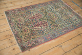 Vintage Kerman rug thousand flower motif in pale red, blue, green on ivory field.