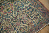 Vintage Kerman rug displaying intricate thousand flower pattern in ivory, pale red, and blue tones.