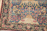 Antique Kerman rug corner with a pictorial bird, pink blossoms on blue, and a beige floral border.