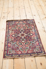 Antique Persian Kerman rug corner showcasing cochineal red field, unusual sand spandrel, and floral arabesques.