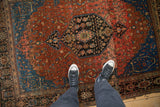 Vintage Josan Sarouk rug from an overhead view, showing the dark medallion and red floral field.