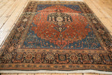 Perspective view of a vintage Josan Sarouk rug highlighting the low-pile texture across its red and blue design.