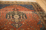 Angled perspective of the Josan Sarouk rug's dark medallion, red field, and blue spandrel.