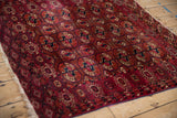 Intricate snowflake and germinating plant borders of a hand-knotted antique Turkmen rug.