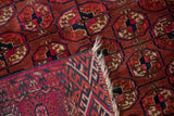 A corner reveals the hand-knotted foundation and secured selvage of the antique Turkmen rug.