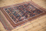 Antique Afshar rug's allover serrated leaf design and original plain weave ends shown from a high angle.