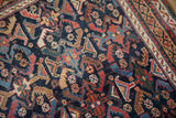 Vivid, naturally-dyed colors in the serrated leaf motifs of a hand-knotted antique Afshar rug.