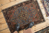 A vintage Farahan Sarouk rug mat with a geometric medallion, shown from above for scale reference.