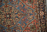 Detail of the Persian rug's intricate Josan border with meandering vine and pinwheel motifs.