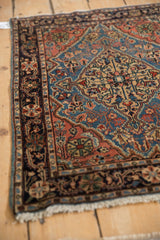 Corner view of a vintage Farahan Sarouk mat detailing its intricate navy Josan border.
