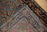 Hand-knotted back and intact side cord finish of a vintage Persian Sarouk rug corner.