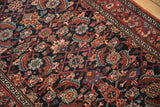 Saturated sapphire and cherry red tones in the allover pattern of a hand-knotted Malayer rug.