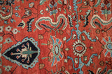 Close-up of polychromatic leaves and palmettes on a vintage Sarouk's brick red field.