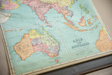 Vintage Nystrom map's lower section displaying Australia, title, and wooden dowel.