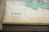 Vintage Nystrom map's lower section, Europe title, legend, and torn left edge with dowel.