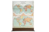 Vintage Nystrom pull-down map displaying Western, Eastern, and full world projections with pastel colors.