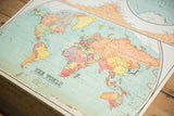 Vintage Nystrom 1930s world map detail, showing Van Der Grinten's Projection and pastel hues.