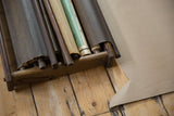 Vintage wooden cassette map rack interior, showing dark dowels and rolled reference maps.
