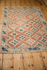 Distressed Dosemealti rug with even wear, featuring faded terracotta and sapphire geometric guls.